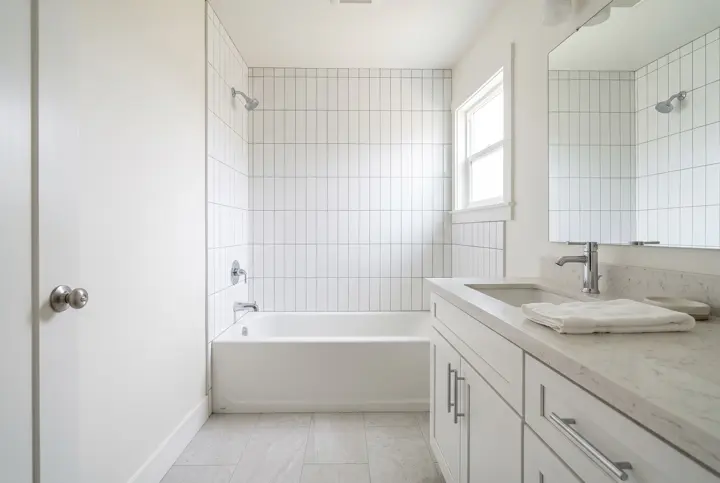 Hall bathroom with a tub and shower combination and vertical white subway tile