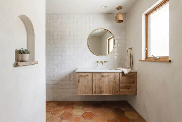A Spanish-modern bathroom with a terracotta Saltillo tile floor