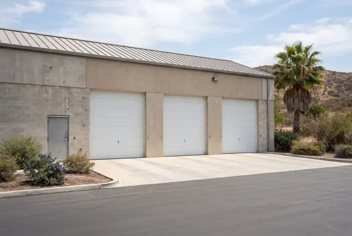 A completed maintenance building with a smooth concrete-block and stucco exterior