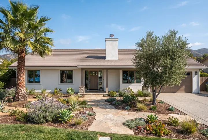 A single-story stucco home with a new medium-brown flat concrete tile roof with a stucco chimney with a small metal cap and clean flashing