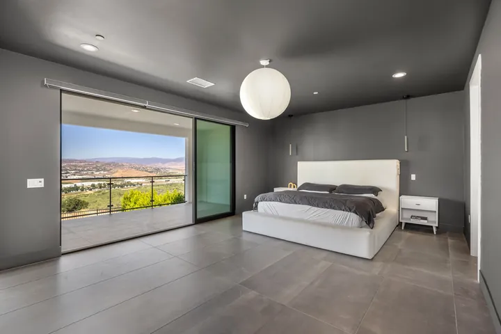 Primary bedroom with a sliding glass door and valley views, interior renovation in Santa Clarita, CA, photo 14