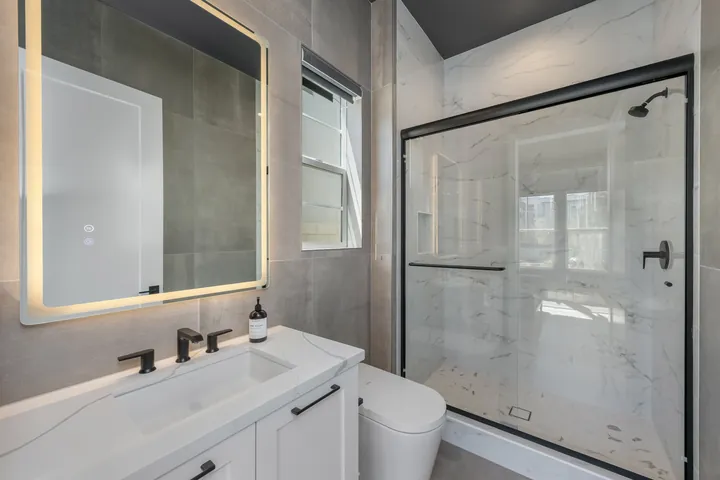 Bathroom with a backlit vanity mirror, quartz counter and glass shower, bathroom renovation in Santa Clarita, CA, photo 21
