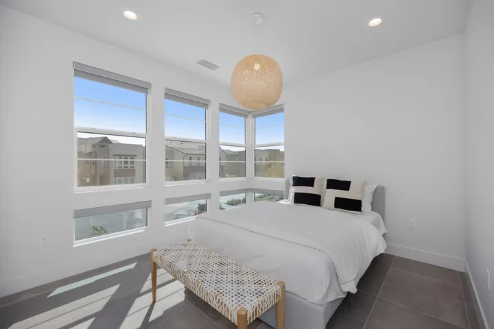 Bright bedroom with corner windows and a woven pendant light, interior renovation in Santa Clarita, CA, photo 27
