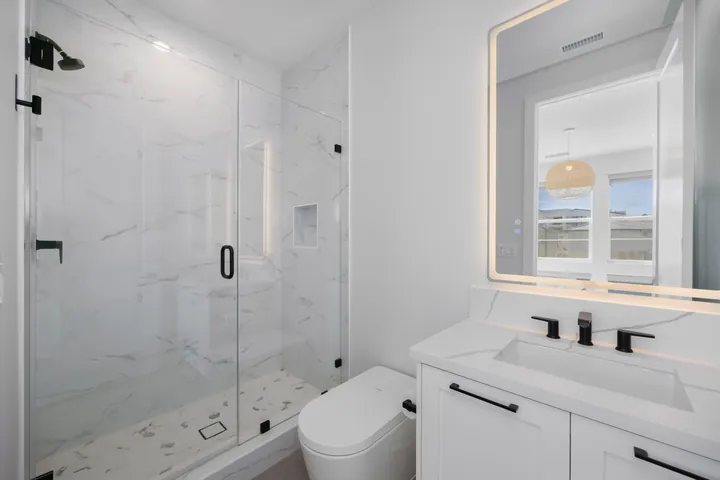 Hall bathroom with a marble-look glass shower, black faucet and a white shaker vanity, bathroom renovation in Santa Clarita, CA, photo 22
