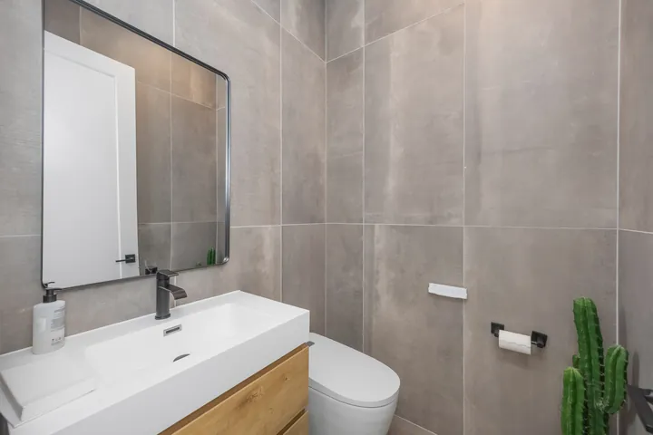 Powder room with a floating wood vanity, matte black mirror and large-format gray tile, bathroom renovation in Santa Clarita, CA, photo 23